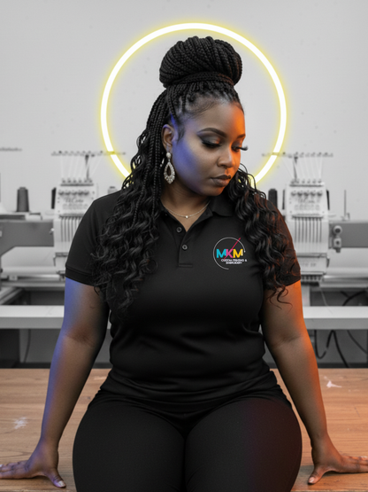A woman wearing a black Performance Polo shirt with a logo in an industrial setting.