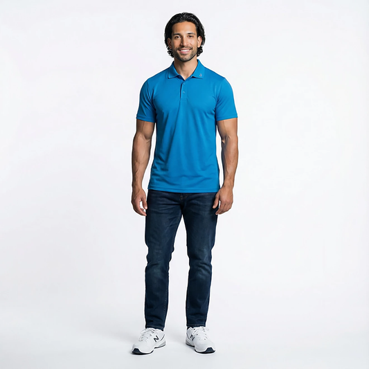 Man wearing a blue polo shirt and dark jeans on a white background