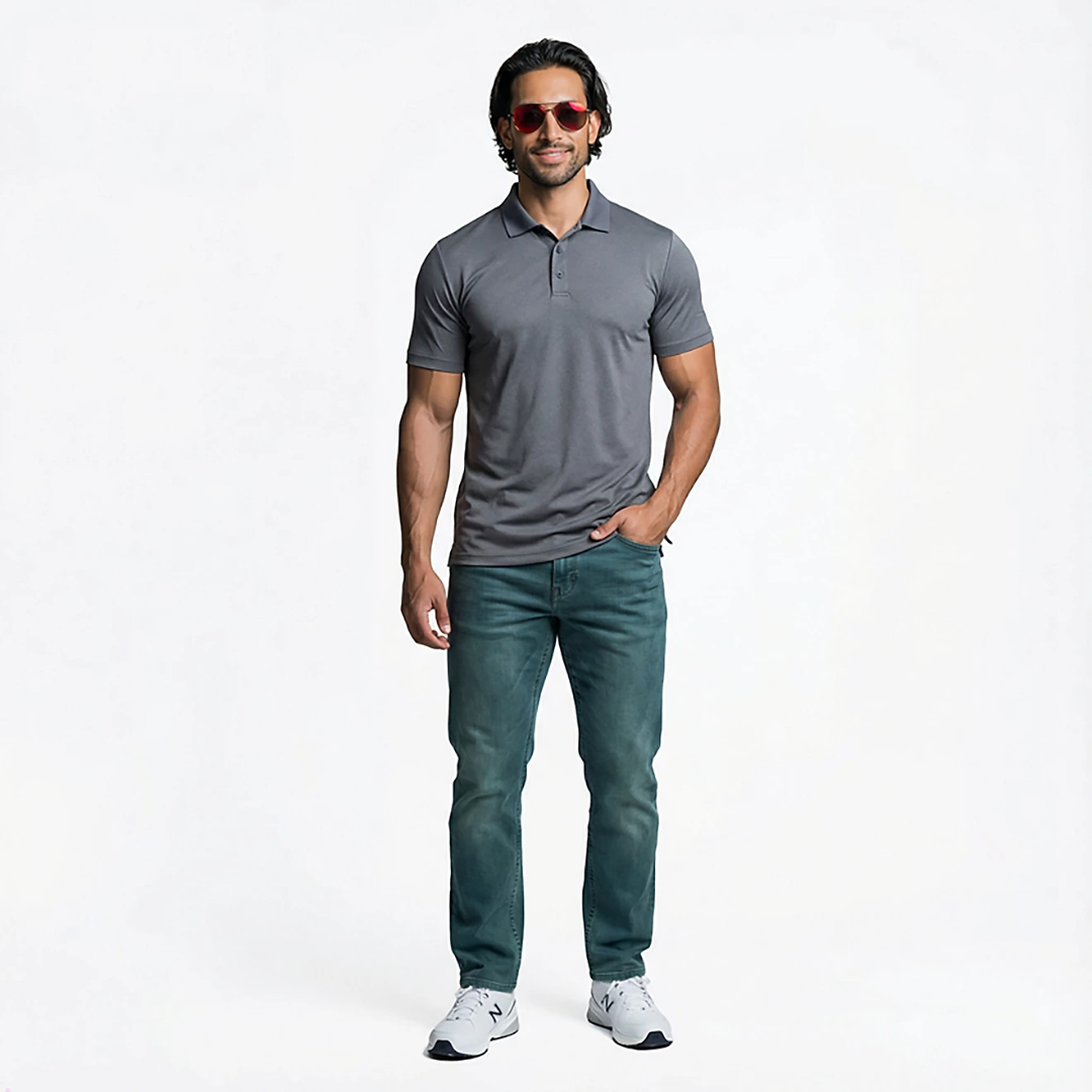 Man wearing a gray polo shirt and blue jeans on a white background