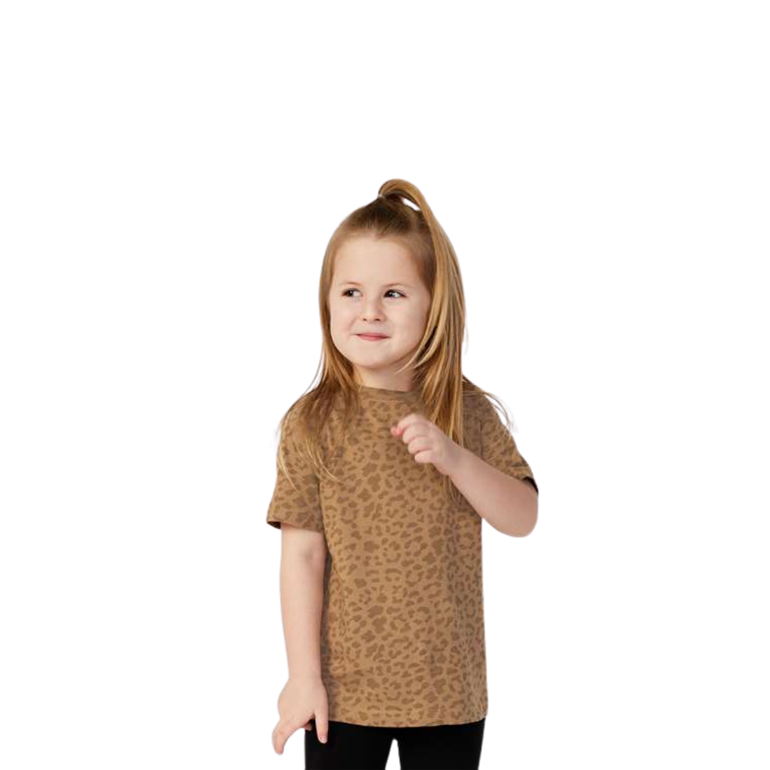 Young girl wearing a brown leopard print shirt on a white background