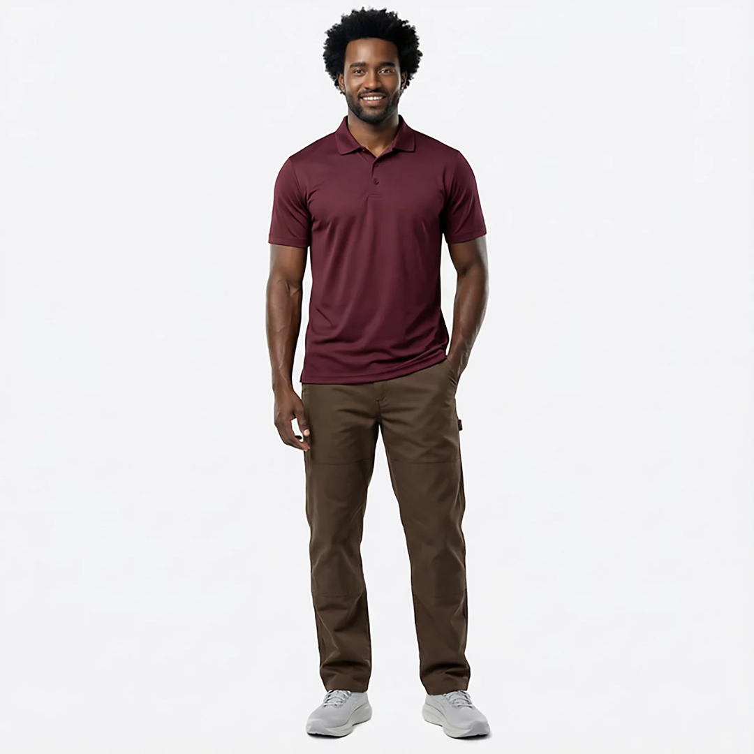 Man wearing a maroon polo shirt and brown pants on a white background